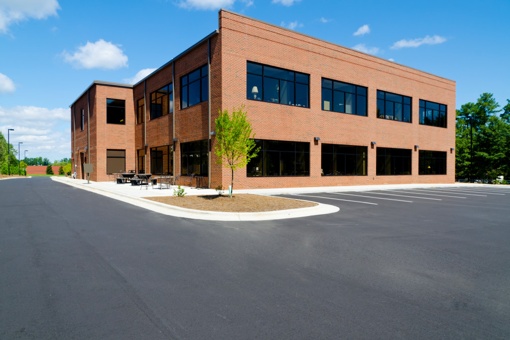 a red brick office with a wide parking lot as a potential office